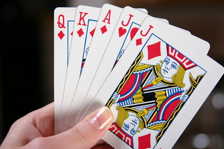hands holding deck of cards