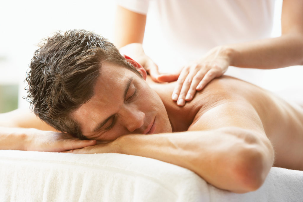 Young Man Enjoying Massage At Spa