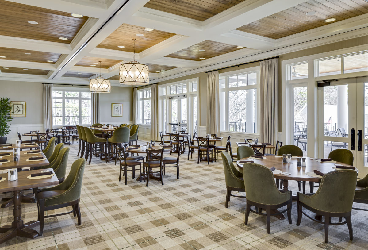 Elegant dining room at Greenville Country Club with light green and gold accents.